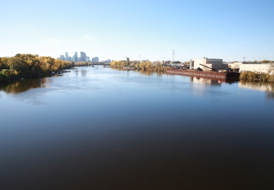 The wide Mississippi River with the Minneapolis skyline on the horizon.